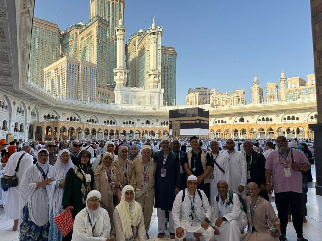 The group in front of the Kaaba at Masjid al-Haram