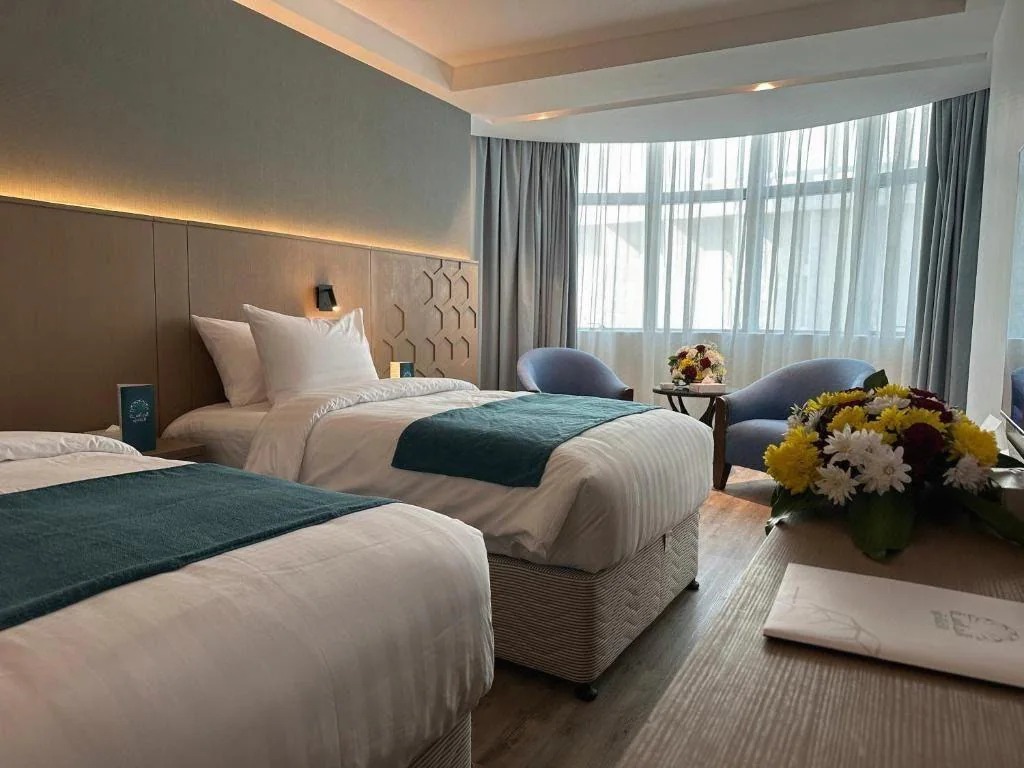 Representative twin guest room at Grand Al Massa Hotel