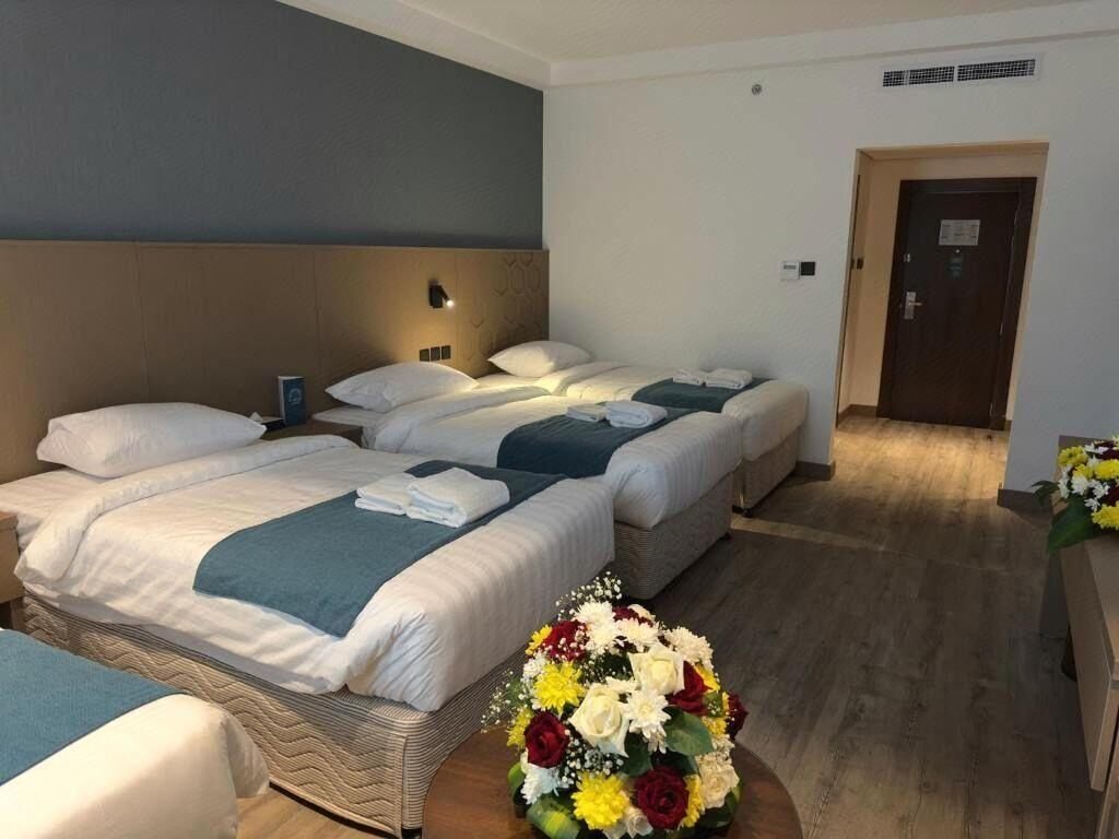 Representative quad guest room at Grand Al Massa Hotel