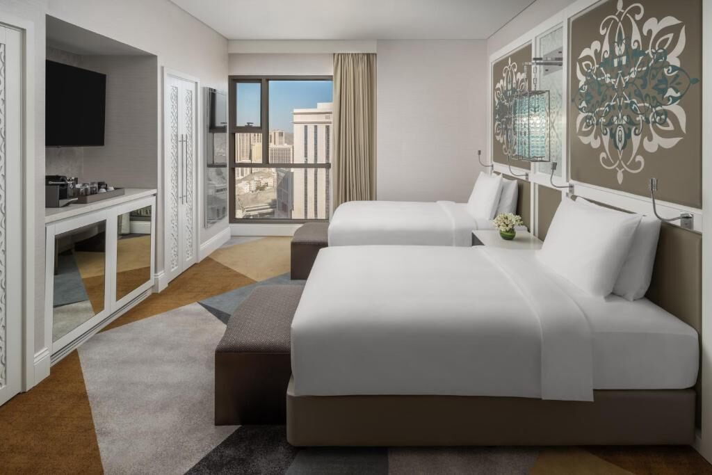 Representative twin guest room at Rotana Jabal Omar with a city view