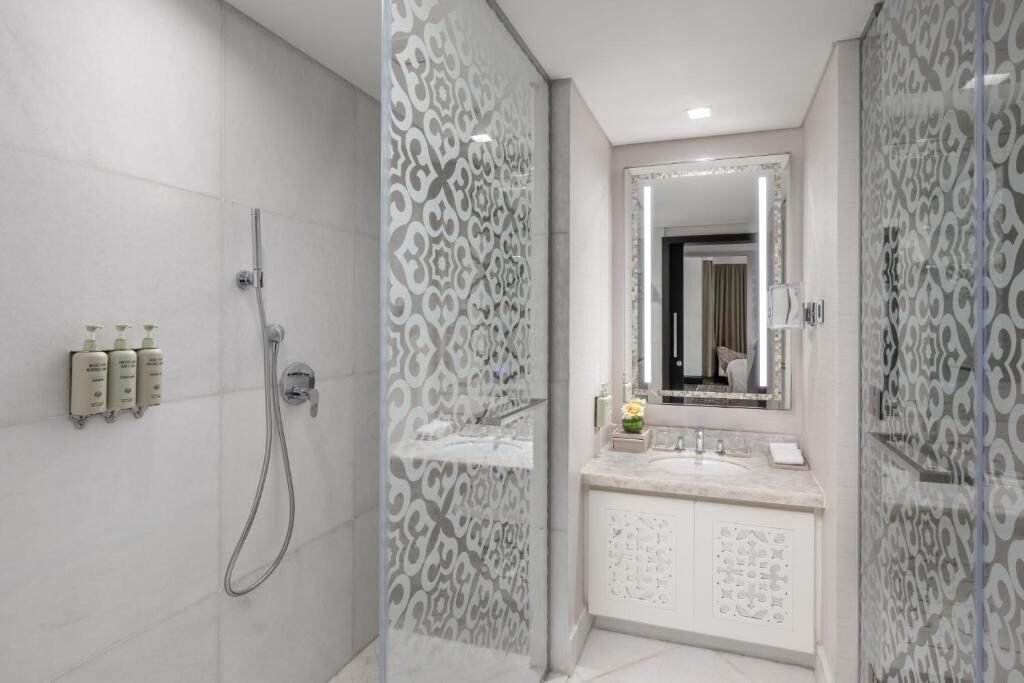 Bathroom with walk-in shower at Rotana Jabal Omar
