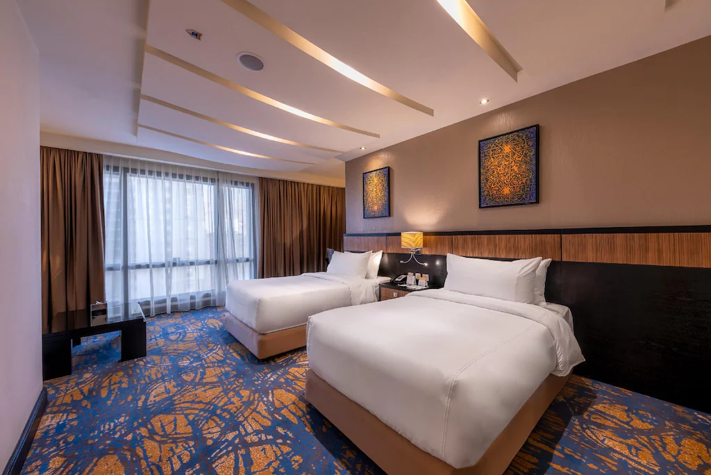 Representative guest room with two double beds at Dar Al Ghufran in Makkah