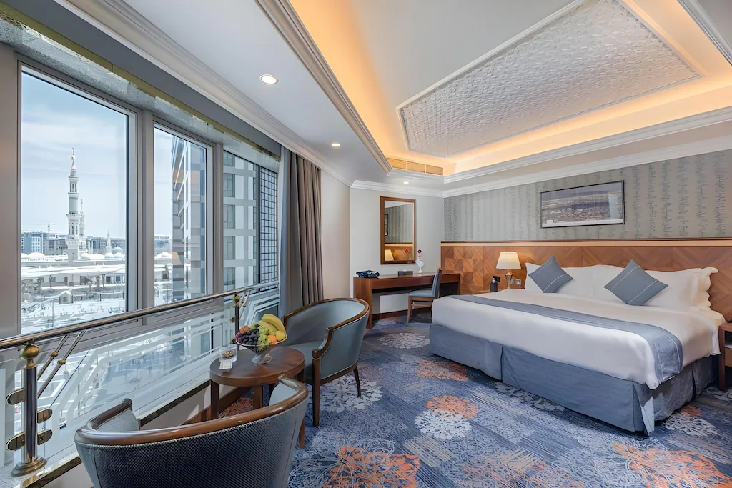 Representative guest room at Maden Hotel with a view toward the minarets of Al-Masjid an-Nabawi