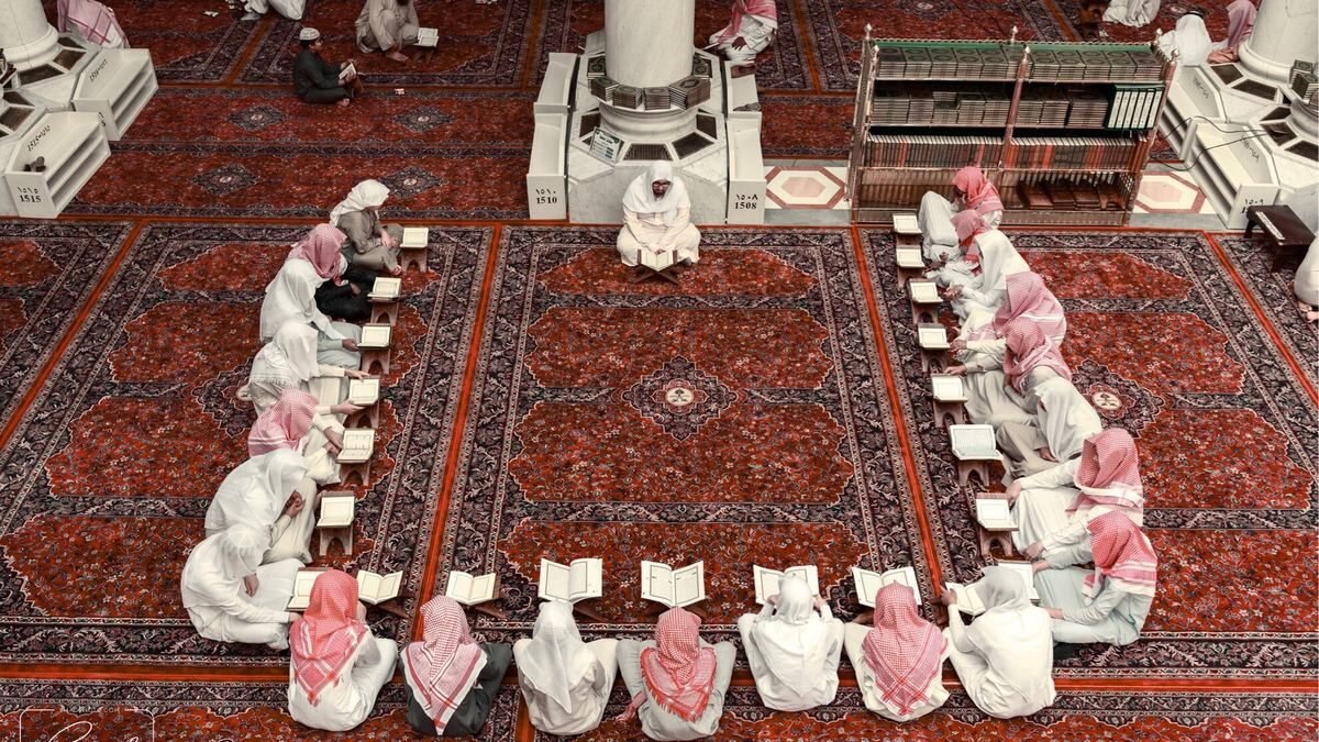 Rows of Zamzam water coolers with paper cups inside the Prophet's Mosque