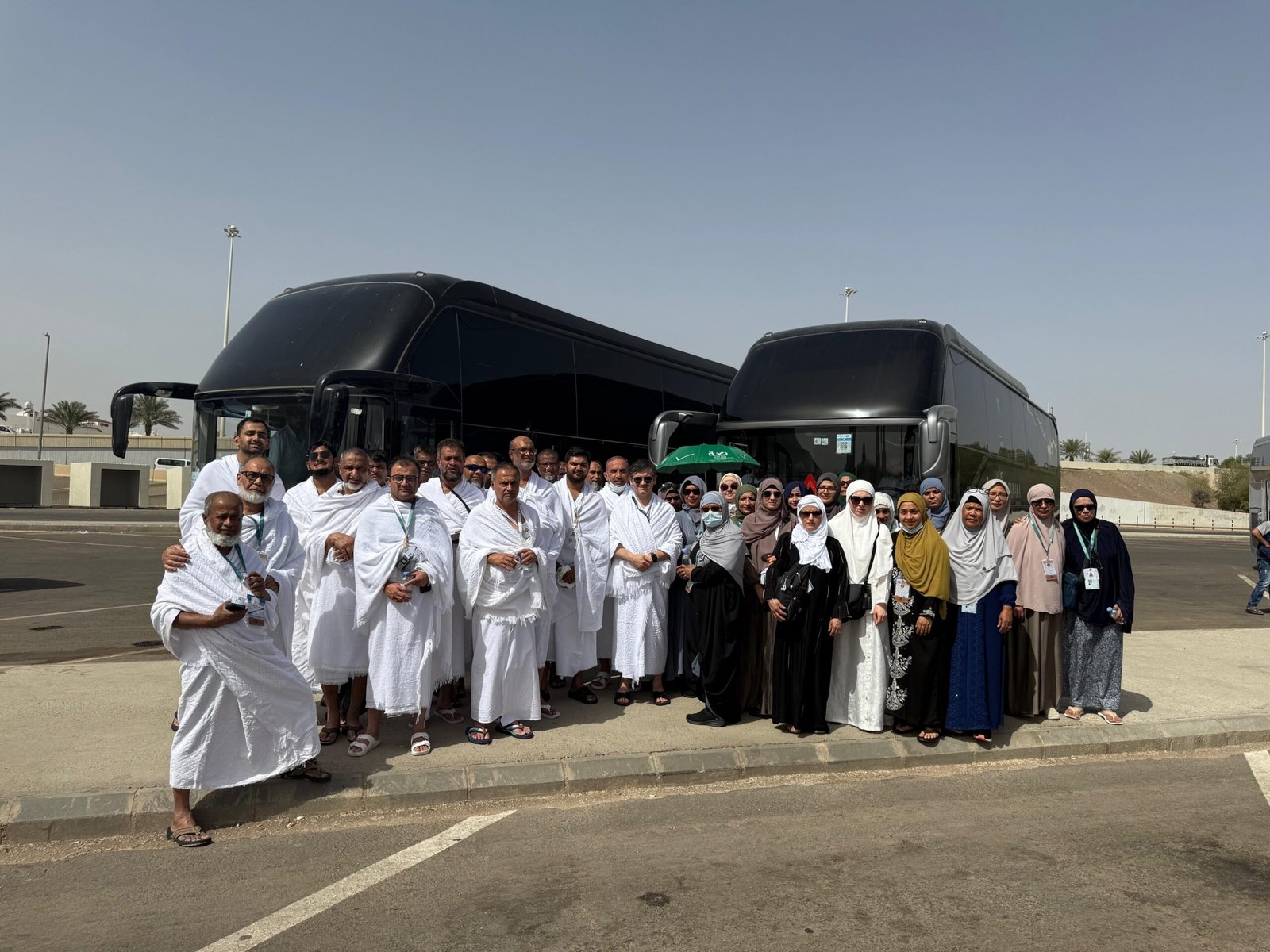 A previous Hisar Tour group in ihram beside the group’s coaches